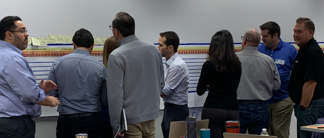 Team members reviewing visual diagram and engaged in discussion